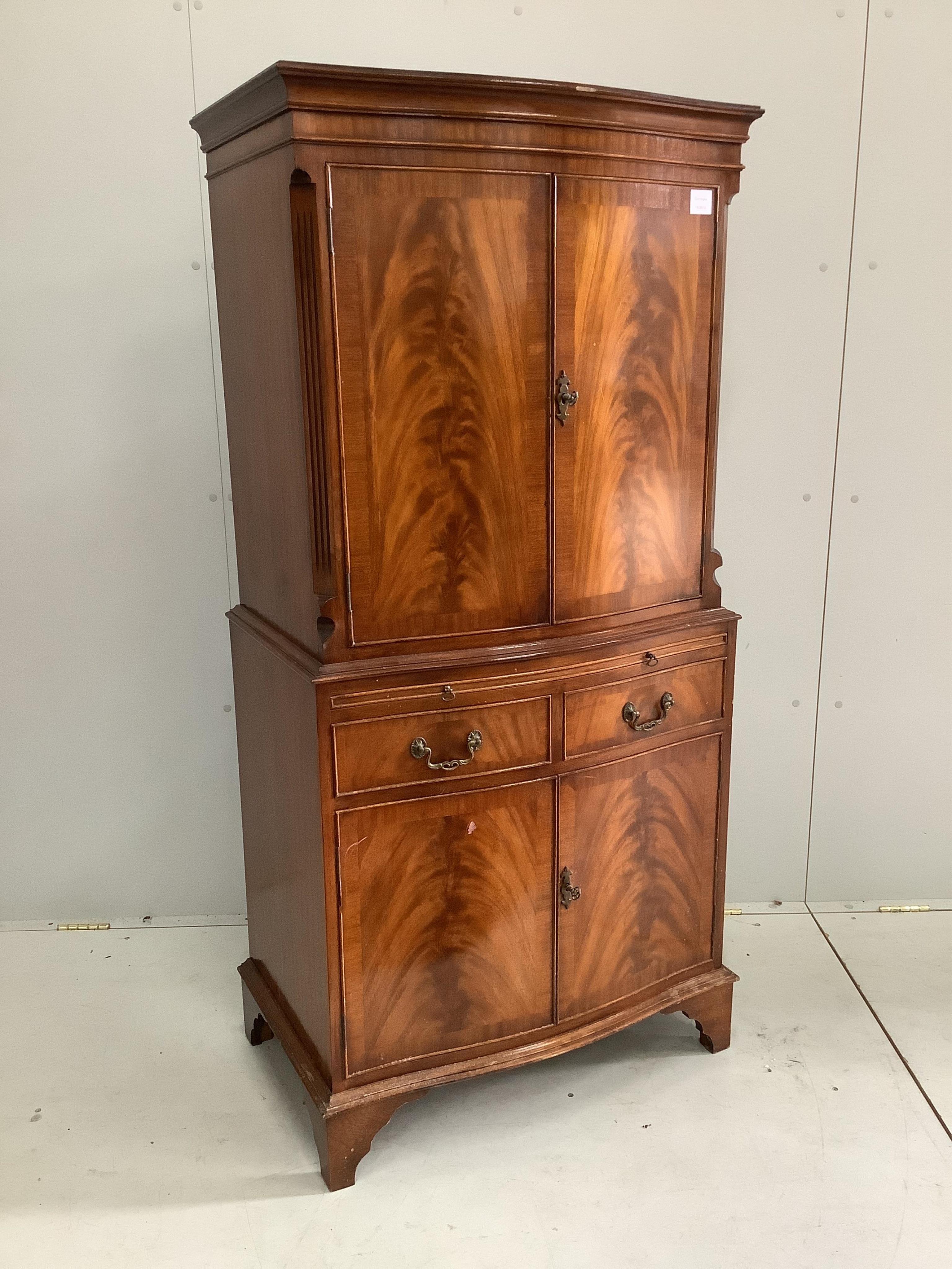 A reproduction serpentine mahogany cocktail cabinet, width 72cm, depth 46cm, height 153cm. Condition - fair